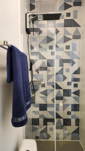 a bathroom with blue towels and a shower at Morada City Hostel in Sao Paulo