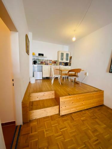 a living room with a wooden floor and a table at Wohnung mit Balkon, Graz Zentrum in Graz