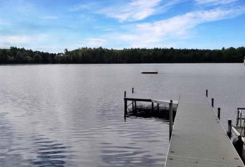 a dock in the middle of a large lake at The Cedar Lakehouse in Lake Tomahawk WI in Lake Tomahawk