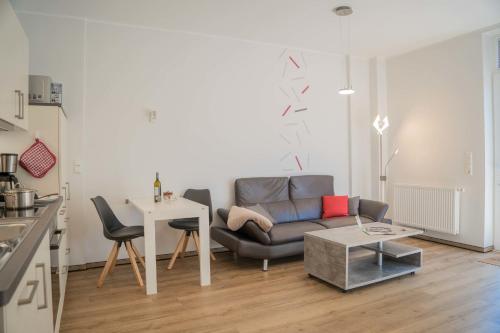a living room with a couch and a table at Scheune 8 in Gollendorf