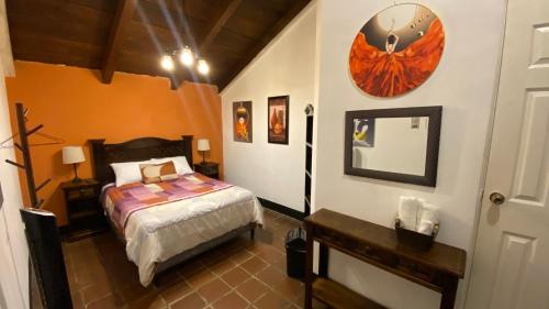 a bedroom with a bed and a mirror on the wall at Hotel y Restaurante San Fernando. in Jocotenango