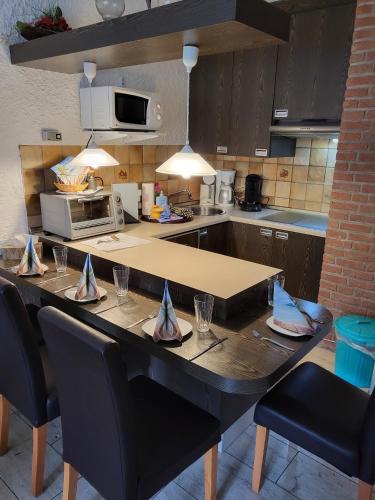 a kitchen with a table with chairs and a microwave at Appartment 025 in Tossens in Tossenserdeich