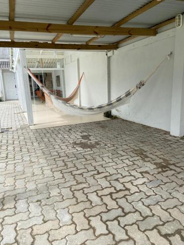 a hammock hanging from a wall in a building at Recanto do Sol Praia do Cassino in Rio Grande