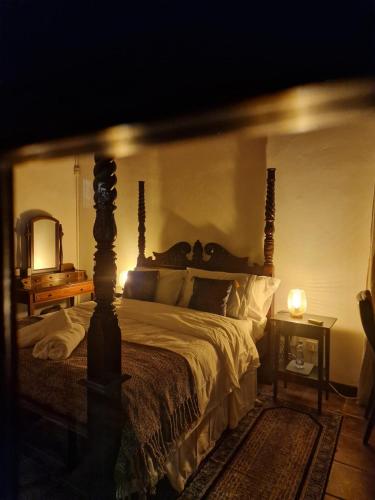 a bedroom with a bed and a mirror and a lamp at The Courtyard Suite in Limassol