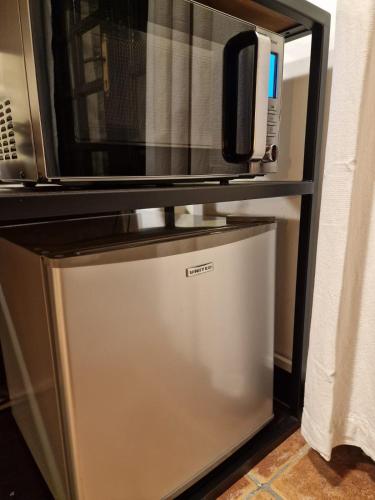 a microwave sitting on top of a refrigerator at The Courtyard Suite in Limassol