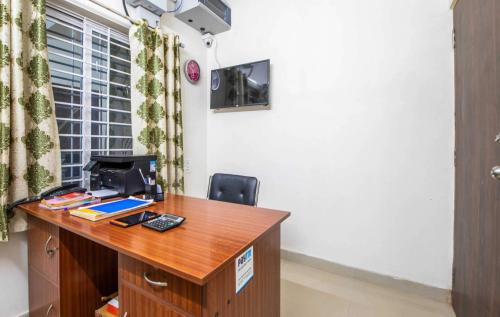 an office with a desk with a computer on it at Hotel O Sagar Comforts in Bengaluru