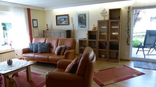a living room with a couch and a table at Haus Gertrud in Lissendorf