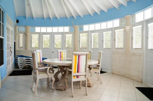 a dining room with a table and chairs at Marzalea in Saint James