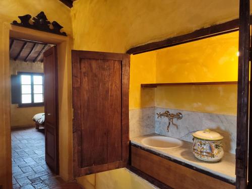 a bathroom with a sink in a room at Podere Rinascidentro in Asciano