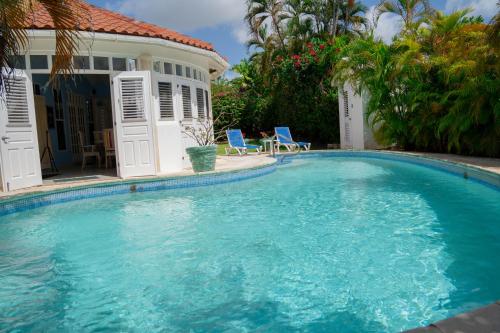 a large swimming pool in front of a house at Marzalea in Saint James