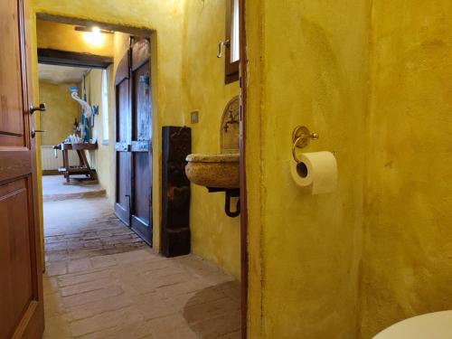 a bathroom with a sink and a toilet paper roll at Podere Rinascidentro in Asciano