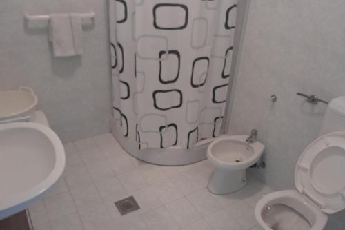 a bathroom with a shower and a toilet and a sink at Apartments with parking space Lopar, Rab - 23747 in Lopar