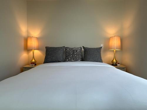 a bedroom with a large white bed with two lamps at Studio Suite - Walk to Convention Center and Crypto Arena in Los Angeles