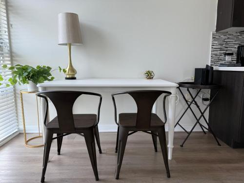 a white table with two chairs and a lamp on it at Studio Suite - Walk to Convention Center and Crypto Arena in Los Angeles