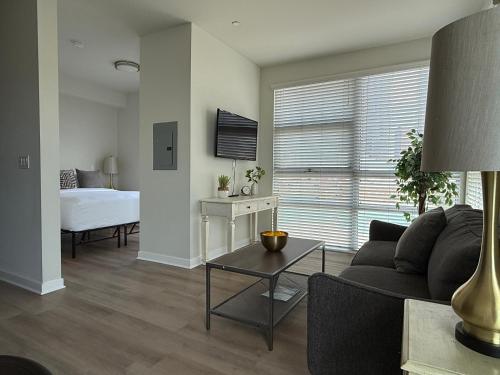 a living room with a couch and a bed at Studio Suite - Walk to Convention Center and Crypto Arena in Los Angeles