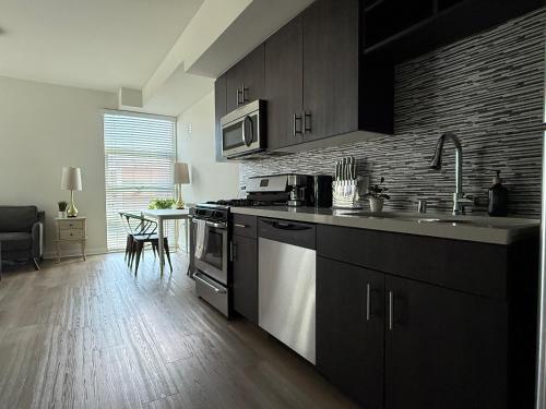 a kitchen with a sink and a stove top oven at Studio Suite - Walk to Convention Center and Crypto Arena in Los Angeles