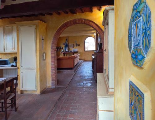 a hallway with an archway in a house with a kitchen at Podere Rinascidentro in Asciano