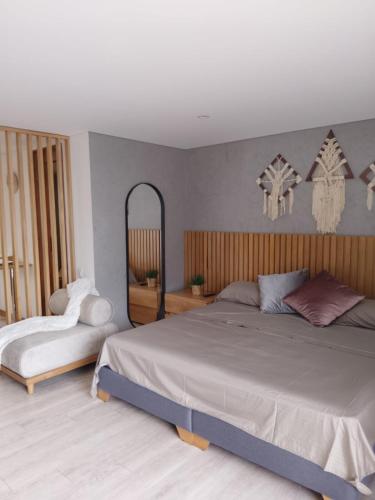 a bedroom with a large bed and a mirror at New Countryside Apartaloft 213 in El Retiro