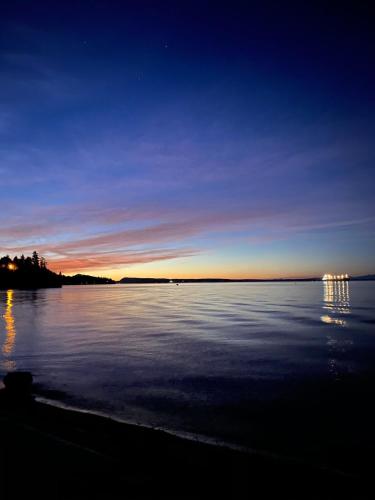 a sunset over a large body of water at The Wayward Inn in Chemainus