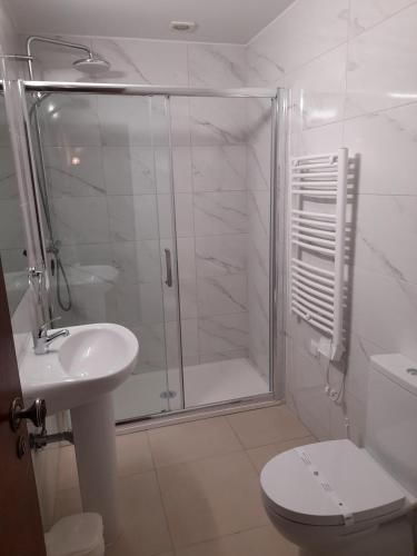 a bathroom with a shower and a toilet and a sink at 413 Casa Marsalema in Salema