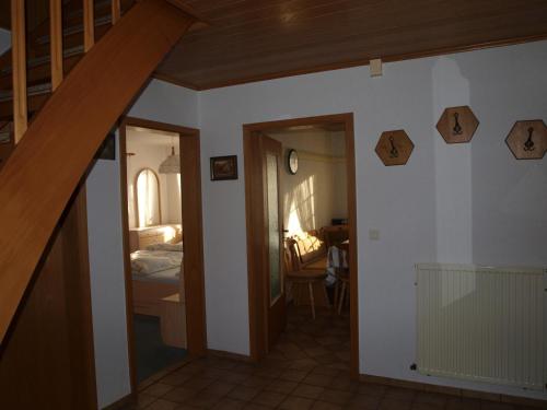 a room with a staircase leading to a bedroom at Ferienhaus auf dem Hof in Wanna
