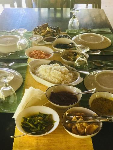 a table full of dishes of food on a table at Wild Wadi Wilpattu - Villas with private Plunge Pools in Wilpattu