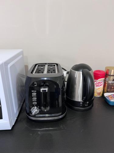 a toaster sitting on a counter next to a microwave at Cozy Ensuite Room with Amenities & Private Entrance in Auckland