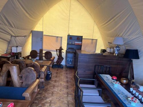 a room with a tent with chairs and tables at Shanxi Merchant Mansion in Pingyao