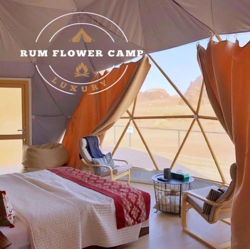 a bed in a tent with a view of the desert at RUM FLOWER lUXURY CAMP in Disah