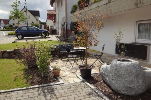a patio with a table and chairs next to a building at EG Villingendorf in Villingendorf
