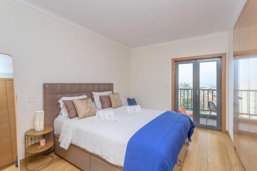 Postel nebo postele na pokoji v ubytování BeGuest Vasco da Gama Apartment