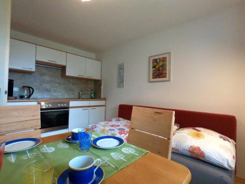 a small kitchen with a table with plates on it at Ferienwohnung Vroni in Altenstadt