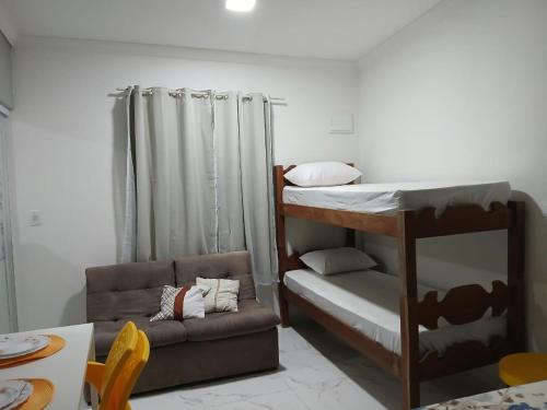 a small room with a bunk bed and a couch at Recife e Olinda - Studio Bastos Residence in Recife