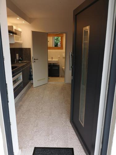 a kitchen with a door open to a kitchen with a sink at Ferienwohnung Schloßberg 2 in Peiting