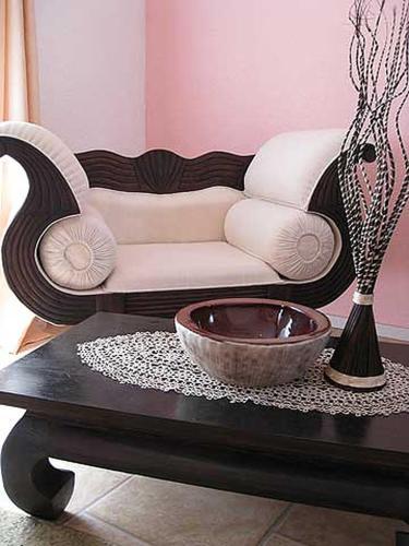 a living room with a couch and a table at Bali Suite in Hoppegarten
