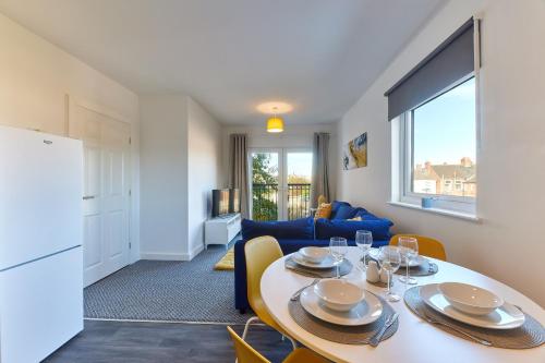 a kitchen and living room with a table and chairs at The Mindrum - Properties Unique in North Shields