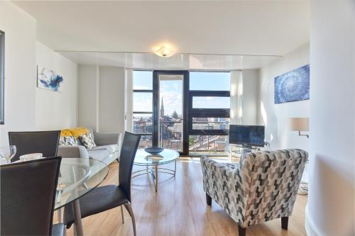 a living room with a couch and a table with chairs at Low Friars - Properties Unique in Newcastle upon Tyne