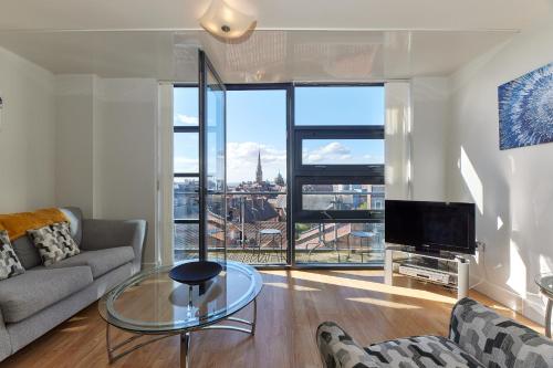 a living room with a couch and a glass table at Low Friars - Properties Unique in Newcastle upon Tyne