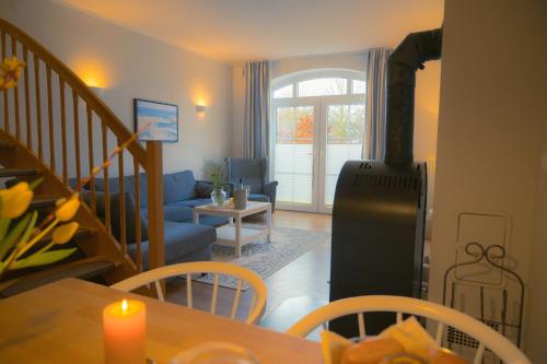 a living room with a table and a living room with a stove at Vento in Westermarkelsdorf