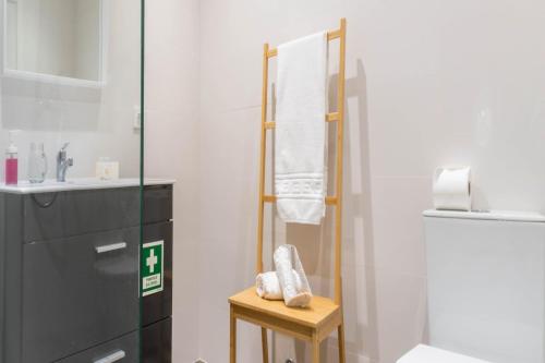 a bathroom with a towel rack and a sink at EnCanto Terrace House in Ponta Delgada
