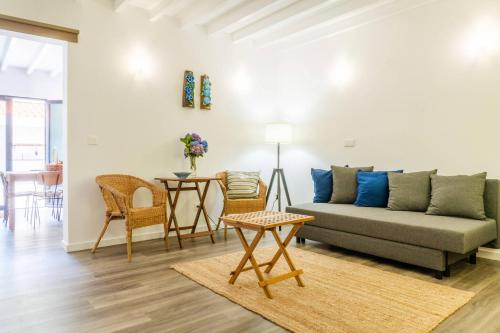 a living room with a couch and a table at Encanto Village House in Faial da Terra