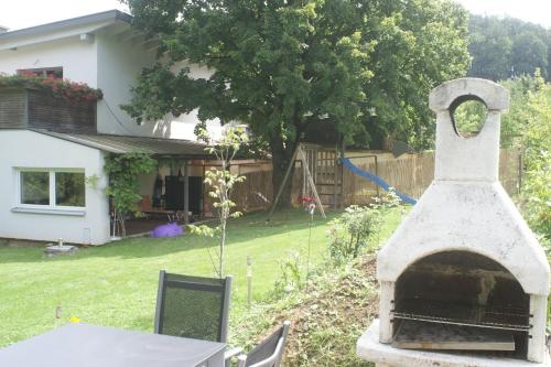 a stone oven in the yard of a house at Ferienhaus Moser in Hart