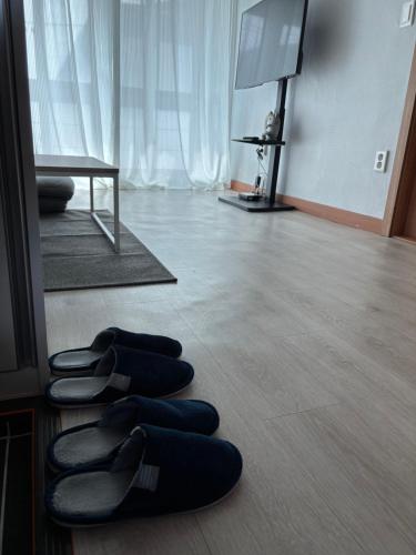 a group of shoes sitting on the floor in front of a mirror at 포항 Jin house in Pohang