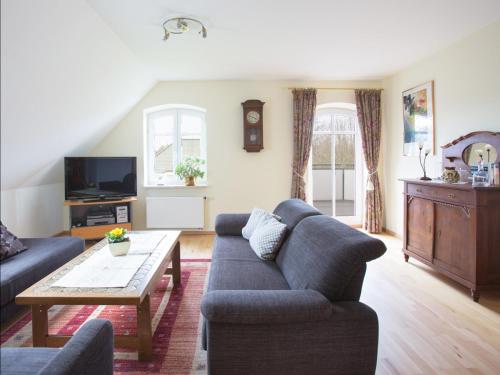 a living room with a couch and a coffee table at Fewo 1 "Landhaus am Grashof" in Offenbüttel