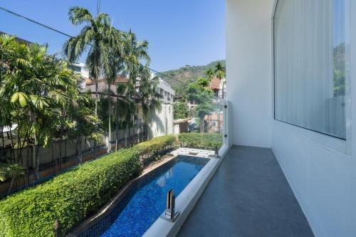 a view from the balcony of a house with a swimming pool at Sunnyside Kata in Kata Beach