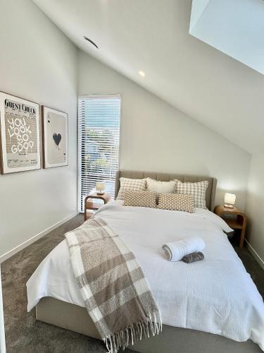 a bedroom with a large bed in a attic at New build City Townhouse & Gated Car Park in Christchurch