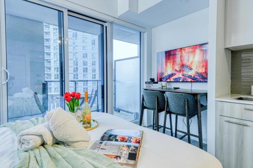 a living room with a table with flowers on it at RivetStays - The Jarvis in Toronto