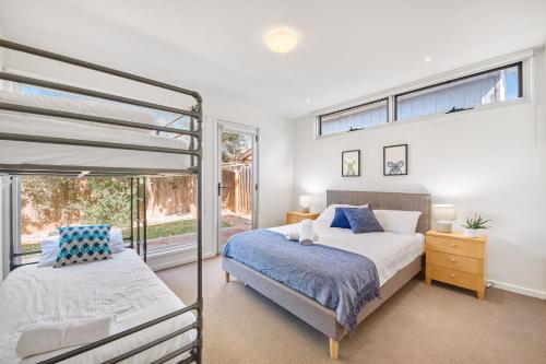 a bedroom with a double bed and a window at Jan Juc Beach Home in Torquay