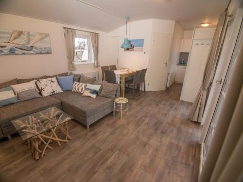 a living room with a couch and a table at Strand 15 in Scharbeutz