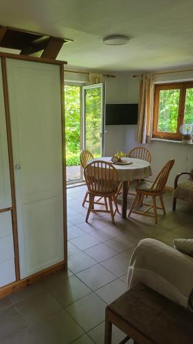 a living room with a table and chairs at Gut Hanerau, Eschenufer keine Monteure in Hanerau-Hademarschen